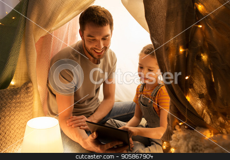 To use this stock image in your creative project, please select the size you need over to the right and click the "Add to Cart" button.
Your downloaded image will come with the Cutcaster watermark removed so don’t worry about the watermark you see on this page. family with tablet pc in kids tent at home stock photo, family, hygge and technology concept - happy father and little daughter with tablet pc computer in kids tent at night at home by Syda Productions