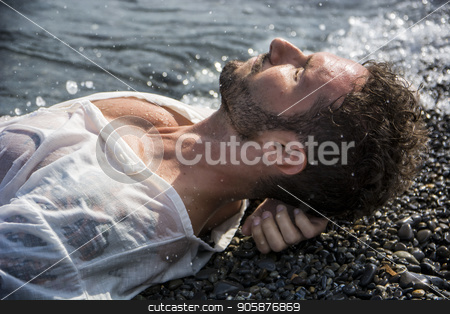 To use this stock image in your creative project, please select the size you need over to the right and click the "Add to Cart" button.
Your downloaded image will come with the Cutcaster watermark removed so don’t worry about the watermark you see on this page. Handsome muscular man on the beach laying on gravel stock photo, Handsome muscular man on the beach lying on gravel, wearing wet white shirt by Stefano Cavoretto