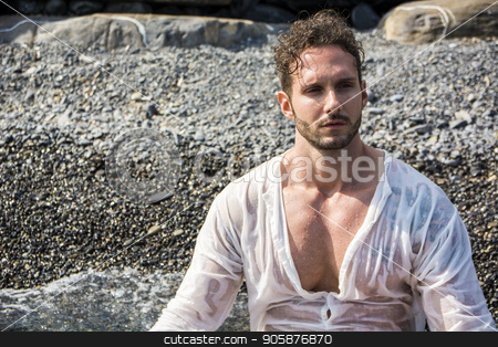 To use this stock image in your creative project, please select the size you need over to the right and click the "Add to Cart" button.
Your downloaded image will come with the Cutcaster watermark removed so don’t worry about the watermark you see on this page. Handsome muscular man on the beach laying on gravel stock photo, Handsome muscular man on the beach lying on gravel, wearing wet white shirt by Stefano Cavoretto