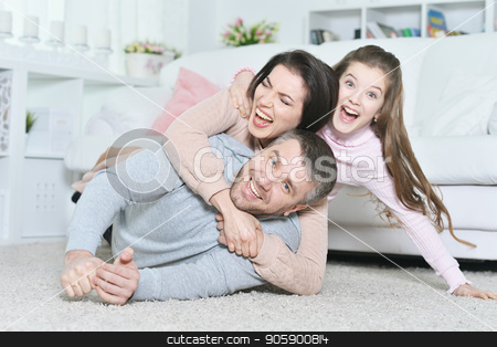 To use this stock image in your creative project, please select the size you need over to the right and click the "Add to Cart" button.
Your downloaded image will come with the Cutcaster watermark removed so don’t worry about the watermark you see on this page. Close up portrait of cute little girl with her parents stock photo, Close up portrait of cute little girl with her parents posing by Ruslan Huzau