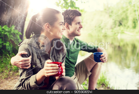 To use this stock image in your creative project, please select the size you need over to the right and click the "Add to Cart" button.
Your downloaded image will come with the Cutcaster watermark removed so don’t worry about the watermark you see on this page. happy couple with cups drinking in nature stock photo, travel, tourism, hike, camping and people concept - happy couple with cups drinking tea in nature on river bank by Syda Productions