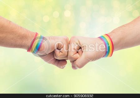 To use this stock image in your creative project, please select the size you need over to the right and click the "Add to Cart" button.
Your downloaded image will come with the Cutcaster watermark removed so don’t worry about the watermark you see on this page. hands with gay pride wristbands make fist bump stock photo, lgbt, same-sex love and homosexual relationships concept - close up of male couple hands with gay pride rainbow awareness wristbands making fist bump gesture over green lights background by Syda Productions