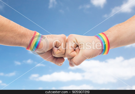 To use this stock image in your creative project, please select the size you need over to the right and click the "Add to Cart" button.
Your downloaded image will come with the Cutcaster watermark removed so don’t worry about the watermark you see on this page. hands with gay pride wristbands make fist bump stock photo, lgbt, same-sex love and homosexual relationships concept - close up of male couple hands with gay pride rainbow awareness wristbands making fist bump gesture over blue sky and clouds background by Syda Productions
