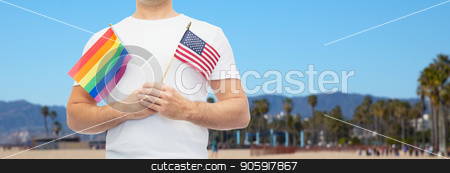 To use this stock image in your creative project, please select the size you need over to the right and click the "Add to Cart" button.
Your downloaded image will come with the Cutcaster watermark removed so don’t worry about the watermark you see on this page. man with gay pride rainbow flag and american stock photo, lgbt, same-sex relationships and homosexual concept - close up of man holding gay pride rainbow and american flag over venice beach background in california by Syda Productions