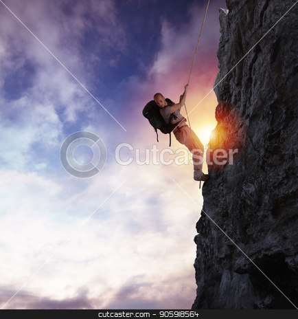 To use this stock image in your creative project, please select the size you need over to the right and click the "Add to Cart" button.
Your downloaded image will come with the Cutcaster watermark removed so don’t worry about the watermark you see on this page. Man climbs a high danger mountain with a rope during sunset stock photo, Explorer man climbs a high danger mountain with a rope during sunset by Federico Caputo