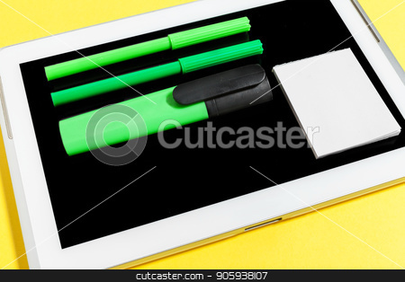 stationary lying on the switched off screen of a tablet pc stock photo watermarked stationary
