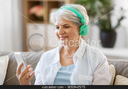 To use this stock image in your creative project, please select the size you need over to the right and click the "Add to Cart" button.
Your downloaded image will come with the Cutcaster watermark removed so don’t worry about the watermark you see on this page. senior woman in headphones listening to music stock photo, technology, people and lifestyle concept - happy senior woman in headphones and smartphone listening to music at home by Syda Productions