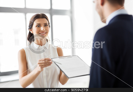 To use this stock image in your creative project, please select the size you need over to the right and click the "Add to Cart" button.
Your downloaded image will come with the Cutcaster watermark removed so don’t worry about the watermark you see on this page. realtor showing contract document to customer stock photo, real estate business, sale and people concept - female realtor with clipboard showing contract document to customers at new office room by Syda Productions