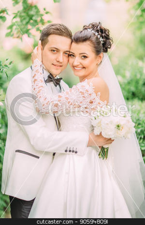 To use this stock image in your creative project, please select the size you need over to the right and click the "Add to Cart" button.
Your downloaded image will come with the Cutcaster watermark removed so don’t worry about the watermark you see on this page. Side portrait of the hugging newlyweds holding the wedding bouquet. stock photo, Side portrait of the hugging newlyweds holding the wedding bouquet by Andrii Kobryn