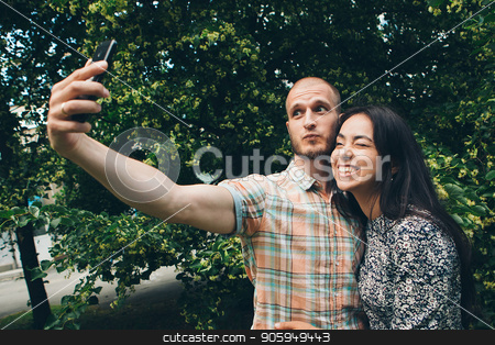 To use this stock image in your creative project, please select the size you need over to the right and click the "Add to Cart" button.
Your downloaded image will come with the Cutcaster watermark removed so don’t worry about the watermark you see on this page. A guy with a girl taking selfies on a green foliage background stock photo, A guy with a girl taking selfies on a green foliage background by aaalll3110