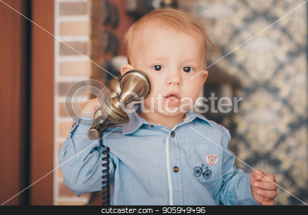 To use this stock image in your creative project, please select the size you need over to the right and click the "Add to Cart" button.
Your downloaded image will come with the Cutcaster watermark removed so don’t worry about the watermark you see on this page. A little blond boy in a blue shirt is calling on the phone stock photo, A little blond boy in a blue shirt is calling on the phone by aaalll3110