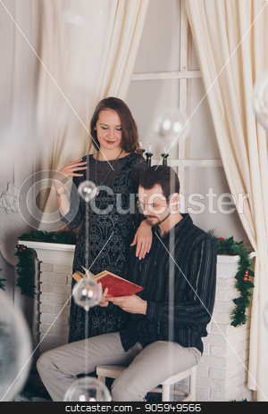 To use this stock image in your creative project, please select the size you need over to the right and click the "Add to Cart" button.
Your downloaded image will come with the Cutcaster watermark removed so don’t worry about the watermark you see on this page. guy and girl reading a book at Christmas by the fireplace stock photo, guy and girl reading a book at Christmas by the fireplace by aaalll3110