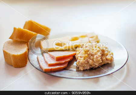 To use this stock image in your creative project, please select the size you need over to the right and click the "Add to Cart" button.
Your downloaded image will come with the Cutcaster watermark removed so don’t worry about the watermark you see on this page. Fresh bread, meat slices, Maasdam cheese, wheat porridge on a transparent glass plate on a white table stock photo, Fresh bread, meat slices, Maasdam cheese, wheat porridge on a transparent glass plate on a white table by aaalll3110