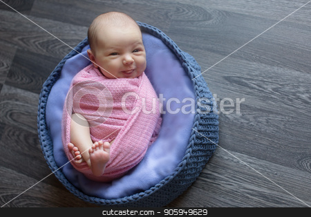 To use this stock image in your creative project, please select the size you need over to the right and click the "Add to Cart" button.
Your downloaded image will come with the Cutcaster watermark removed so don’t worry about the watermark you see on this page. A little child in a pink cap lies on a blue and grey background stock photo, A little child in a pink cap lies on a blue and grey background by aaalll3110