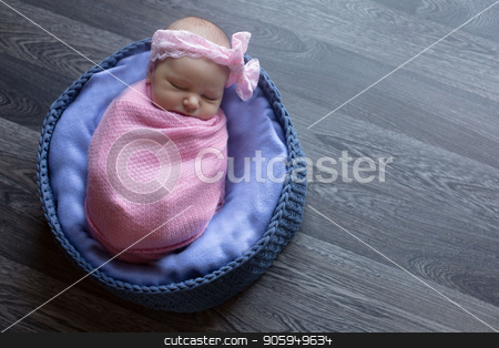 To use this stock image in your creative project, please select the size you need over to the right and click the "Add to Cart" button.
Your downloaded image will come with the Cutcaster watermark removed so don’t worry about the watermark you see on this page. A little child in a pink cap lies on a blue and grey background stock photo, A little child in a pink cap lies on a blue and grey background by aaalll3110