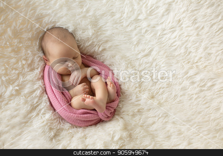 To use this stock image in your creative project, please select the size you need over to the right and click the "Add to Cart" button.
Your downloaded image will come with the Cutcaster watermark removed so don’t worry about the watermark you see on this page. A little child in a pink diaper lies on a beige background stock photo, A little child in a pink diaper lies on a beige background by aaalll3110