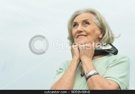 To use this stock image in your creative project, please select the size you need over to the right and click the "Add to Cart" button.
Your downloaded image will come with the Cutcaster watermark removed so don’t worry about the watermark you see on this page. smiling elderly woman stock photo, Portrait of happy smiling elderly woman posing outdoors by Ruslan Huzau