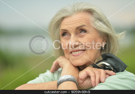 To use this stock image in your creative project, please select the size you need over to the right and click the "Add to Cart" button.
Your downloaded image will come with the Cutcaster watermark removed so don’t worry about the watermark you see on this page. smiling elderly woman stock photo, Portrait of happy smiling elderly woman posing outdoors by Ruslan Huzau