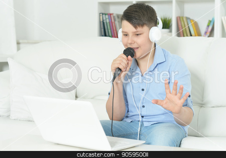 To use this stock image in your creative project, please select the size you need over to the right and click the "Add to Cart" button.
Your downloaded image will come with the Cutcaster watermark removed so don’t worry about the watermark you see on this page. Portrait of boy with microphone stock photo, Portrait of boy with microphone singing at home by Ruslan Huzau