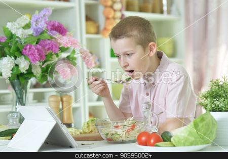 To use this stock image in your creative project, please select the size you need over to the right and click the "Add to Cart" button.
Your downloaded image will come with the Cutcaster watermark removed so don’t worry about the watermark you see on this page. Cute little boy eating salad stock photo, Cute little boy eating salad and looking at tablet screen on kitchen table at home by Ruslan Huzau