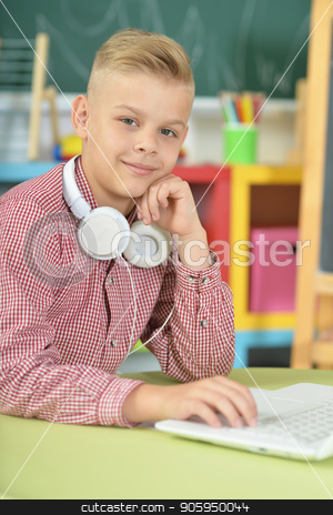 To use this stock image in your creative project, please select the size you need over to the right and click the "Add to Cart" button.
Your downloaded image will come with the Cutcaster watermark removed so don’t worry about the watermark you see on this page. boy with headphones using laptop stock photo, boy with headphones using laptop in classroom by Ruslan Huzau