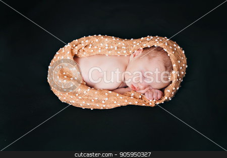 To use this stock image in your creative project, please select the size you need over to the right and click the "Add to Cart" button.
Your downloaded image will come with the Cutcaster watermark removed so don’t worry about the watermark you see on this page. A little child in a beige diaper lies on a black background stock photo, A little child in a beige diaper lies on a black background by aaalll3110