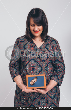 To use this stock image in your creative project, please select the size you need over to the right and click the "Add to Cart" button.
Your downloaded image will come with the Cutcaster watermark removed so don’t worry about the watermark you see on this page. a pregnant woman holding a photo of her unborn child. Isolated photo on white background stock photo, a pregnant woman holding a photo of her unborn child. Isolated photo on white background by aaalll3110