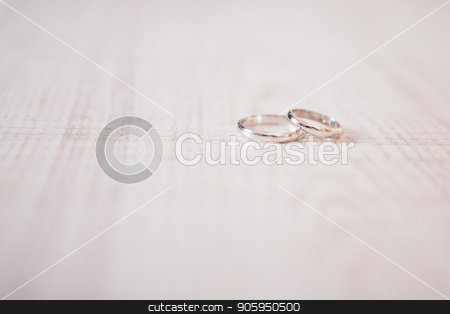 To use this stock image in your creative project, please select the size you need over to the right and click the "Add to Cart" button.
Your downloaded image will come with the Cutcaster watermark removed so don’t worry about the watermark you see on this page. Two gold rings on wooden surface. wedding rings on a light background stock photo, the background for the wedding. suitable for advertising jewelry by aaalll3110