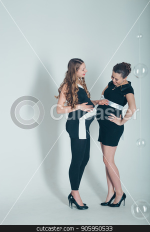 To use this stock image in your creative project, please select the size you need over to the right and click the "Add to Cart" button.
Your downloaded image will come with the Cutcaster watermark removed so don’t worry about the watermark you see on this page. two pregnant women in black and white dresses on white background stock photo, two pregnant women in black and white dresses on white background by aaalll3110