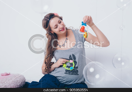 To use this stock image in your creative project, please select the size you need over to the right and click the "Add to Cart" button.
Your downloaded image will come with the Cutcaster watermark removed so don’t worry about the watermark you see on this page. pregnant woman playing with rattle on floor on white background stock photo, pregnant woman playing with rattle on floor on white background by aaalll3110
