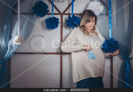 To use this stock image in your creative project, please select the size you need over to the right and click the "Add to Cart" button.
Your downloaded image will come with the Cutcaster watermark removed so don’t worry about the watermark you see on this page. pregnant woman holding baby booties on the belly. fashion for newborns. Children's shoes advertising stock photo, pregnant woman holding baby booties on the belly. fashion for newborns. Children's shoes advertising by aaalll3110