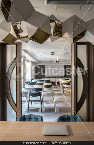 To use this stock image in your creative project, please select the size you need over to the right and click the "Add to Cart" button.
Your downloaded image will come with the Cutcaster watermark removed so don’t worry about the watermark you see on this page. Modern conference hall stock photo, Contemporary conference hall with white walls and a gray floor. There are many light and dark chairs, board, projector, tables with soft chairs, wide door, hanging fancy lamps. Vertical. by bezikus
