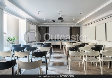 To use this stock image in your creative project, please select the size you need over to the right and click the "Add to Cart" button.
Your downloaded image will come with the Cutcaster watermark removed so don’t worry about the watermark you see on this page. Modern conference hall stock photo, Light conference hall with white walls and a gray floor. There are many light and dark chairs, board, projector, tables with soft chairs, lamps, plant in a pot. Horizontal. by bezikus