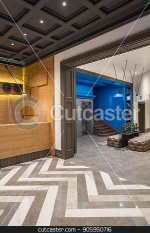 To use this stock image in your creative project, please select the size you need over to the right and click the "Add to Cart" button.
Your downloaded image will come with the Cutcaster watermark removed so don’t worry about the watermark you see on this page. Stylish interior in hotel stock photo, Contemporary hallway in the hotel with different walls and a tiled floor. There is a wooden reception desk, lift, brown stair, shelves with books, black stand with plants, sofas, luminous lamps. by bezikus