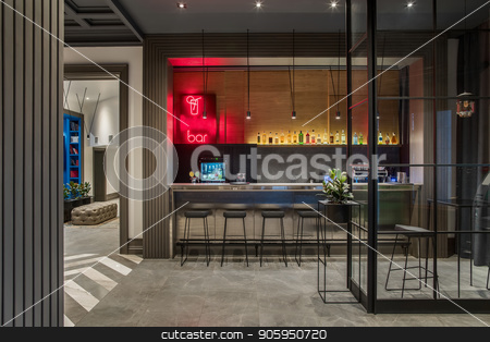 To use this stock image in your creative project, please select the size you need over to the right and click the "Add to Cart" button.
Your downloaded image will come with the Cutcaster watermark removed so don’t worry about the watermark you see on this page. Luminous bar in hotel stock photo, Stylish bar in the hotel with light walls and a gray tiled floor. There is a glossy bar rack with black chairs, small tables, shelf with drinks, coffee machine, green plants, luminous lamps. by bezikus