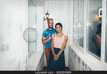 To use this stock image in your creative project, please select the size you need over to the right and click the "Add to Cart" button.
Your downloaded image will come with the Cutcaster watermark removed so don’t worry about the watermark you see on this page. Family portrait of husband and wife. The pair on the balcony. European hugs Asian. Man and woman smiling stock photo, Family portrait of husband and wife. The pair on the balcony. European hugs Asian. Man and woman smiling by aaalll3110
