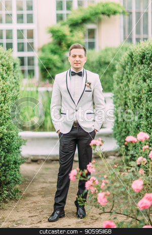 To use this stock image in your creative project, please select the size you need over to the right and click the "Add to Cart" button.
Your downloaded image will come with the Cutcaster watermark removed so don’t worry about the watermark you see on this page. Full-length photo of the groom holding the hands in pockets in the garden. stock photo, Full-length photo of the groom holding the hands in pockets in the garden by Andrii Kobryn