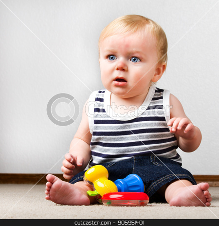 To use this stock image in your creative project, please select the size you need over to the right and click the "Add to Cart" button.
Your downloaded image will come with the Cutcaster watermark removed so don’t worry about the watermark you see on this page. Child playing with his toys stock photo, Young toddler sitting up on the floor with a ring and a toy hammer to play with. by txking