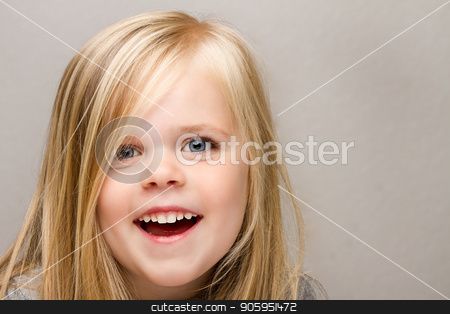 To use this stock image in your creative project, please select the size you need over to the right and click the "Add to Cart" button.
Your downloaded image will come with the Cutcaster watermark removed so don’t worry about the watermark you see on this page. Young girl with a huge smile on her face. stock photo, A Close up shot of a young girl laughing isolated against a medium gray background. by txking