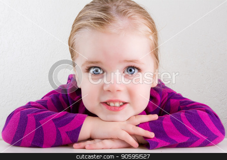 To use this stock image in your creative project, please select the size you need over to the right and click the "Add to Cart" button.
Your downloaded image will come with the Cutcaster watermark removed so don’t worry about the watermark you see on this page. Child resting her head on her hands smiling stock photo, Single child with big bright eyes smiling straight at the camera by txking
