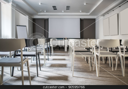 To use this stock image in your creative project, please select the size you need over to the right and click the "Add to Cart" button.
Your downloaded image will come with the Cutcaster watermark removed so don’t worry about the watermark you see on this page. Modern conference hall stock photo, Beautiful conference hall with white walls and a gray floor. There are many light and dark chairs, boards, tables with blue chairs, lamps, window. Horizontal. by bezikus
