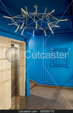 To use this stock image in your creative project, please select the size you need over to the right and click the "Add to Cart" button.
Your downloaded image will come with the Cutcaster watermark removed so don’t worry about the watermark you see on this page. Stylish interior in hotel stock photo, Cool interior in a hotel with blue walls and a tiled floor. There is a stair, lift, big light chandelier. Vertical. by bezikus