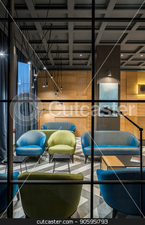 To use this stock image in your creative project, please select the size you need over to the right and click the "Add to Cart" button.
Your downloaded image will come with the Cutcaster watermark removed so don’t worry about the watermark you see on this page. Stylish interior in hotel stock photo, Illuminated interior in the hotel with dark ceiling and patterned tiled floor. There is a wooden reception, column, multicolored armchairs and sofas, tables, different lamps, windows with curtains. by bezikus