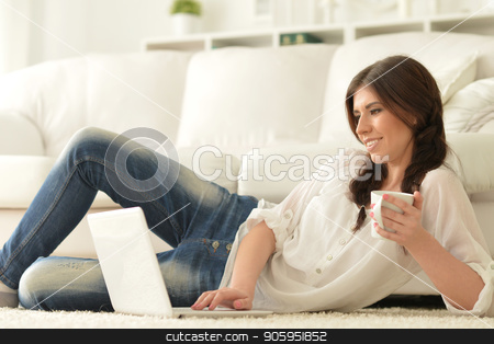To use this stock image in your creative project, please select the size you need over to the right and click the "Add to Cart" button.
Your downloaded image will come with the Cutcaster watermark removed so don’t worry about the watermark you see on this page. beautiful woman using laptop stock photo, young beautiful woman using laptop at home by Ruslan Huzau