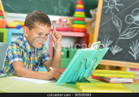 To use this stock image in your creative project, please select the size you need over to the right and click the "Add to Cart" button.
Your downloaded image will come with the Cutcaster watermark removed so don’t worry about the watermark you see on this page. Young boy doing homework stock photo, Young boy doing homework and pointing up with finger in classroom by Ruslan Huzau
