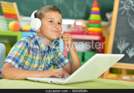 To use this stock image in your creative project, please select the size you need over to the right and click the "Add to Cart" button.
Your downloaded image will come with the Cutcaster watermark removed so don’t worry about the watermark you see on this page. little boy using laptop stock photo, Little boy with headphones using laptop in classroom by Ruslan Huzau
