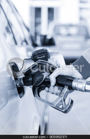 To use this stock image in your creative project, please select the size you need over to the right and click the "Add to Cart" button.
Your downloaded image will come with the Cutcaster watermark removed so don’t worry about the watermark you see on this page. Closeup of mans hand pumping gasoline fuel in car at gas station. stock photo, Pumping gas at gas pump. Closeup of man pumping gasoline fuel in car at gas station. Greyscale blue toned image. by kasto