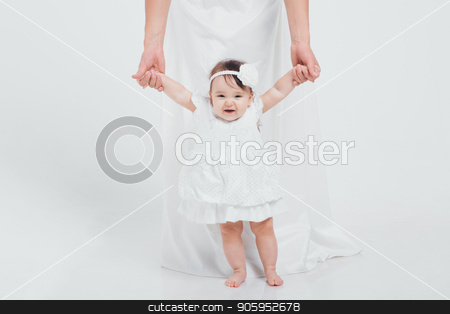 To use this stock image in your creative project, please select the size you need over to the right and click the "Add to Cart" button.
Your downloaded image will come with the Cutcaster watermark removed so don’t worry about the watermark you see on this page. a little girl in a white dress learns to walk holding her mother's hands. Newborn fashion stock photo, a little girl in a white dress learns to walk holding her mother's hands. Newborn fashion by aaalll3110