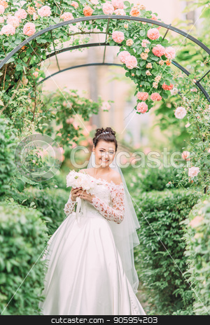 To use this stock image in your creative project, please select the size you need over to the right and click the "Add to Cart" button.
Your downloaded image will come with the Cutcaster watermark removed so don’t worry about the watermark you see on this page. Half-length portrait of the happy bride with wedding bouquet under the arch with roses. stock photo, Half-length portrait of the happy bride with wedding bouquet under the arch with roses by Andrii Kobryn