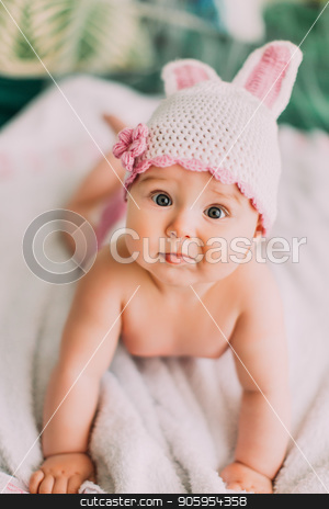 To use this stock image in your creative project, please select the size you need over to the right and click the "Add to Cart" button.
Your downloaded image will come with the Cutcaster watermark removed so don’t worry about the watermark you see on this page. Close-up portrait of the naked baby with the knitted hat lying on the bed. stock photo, Close-up portrait of the naked baby with the knitted hat lying on the bed by Andrii Kobryn